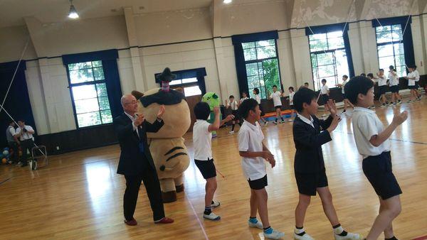 市長とまるいの、まめりんが子供達と一緒に輪になって踊っている写真