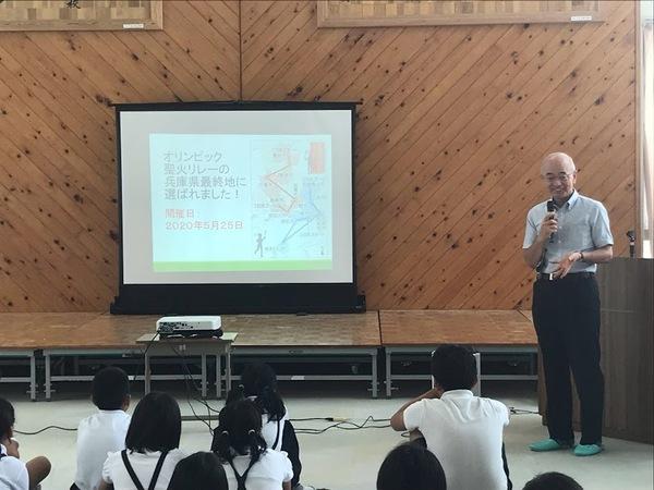 後ろでスクリーンに映しながら市長が子供達に向かって説明している写真