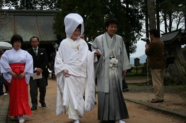 篠山城跡での結婚式で、新郎と新婦が手を取り合い歩いている様子