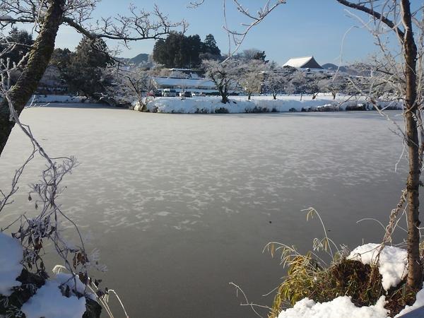 お堀の水が凍って、あたり一面雪景色の写真
