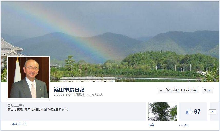 山に虹がかかっている風景と笑顔の市長の写真を掲載したフェイスブックの写真