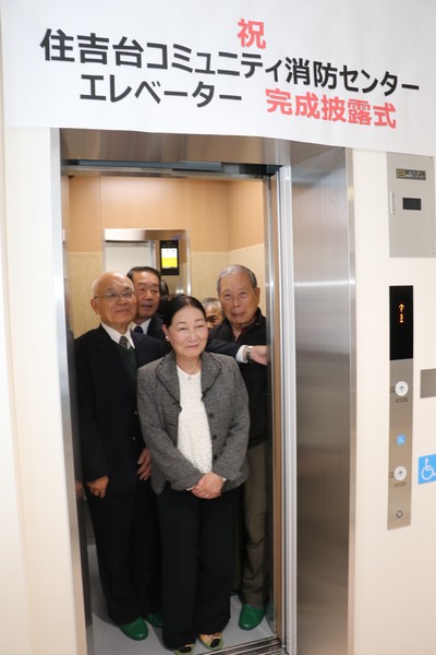 完成エレベーター内に乗りこむ五名の男性女性