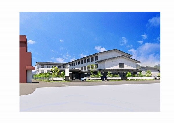 青空の下で大きな建物と敷地内に植栽が植えられている写真