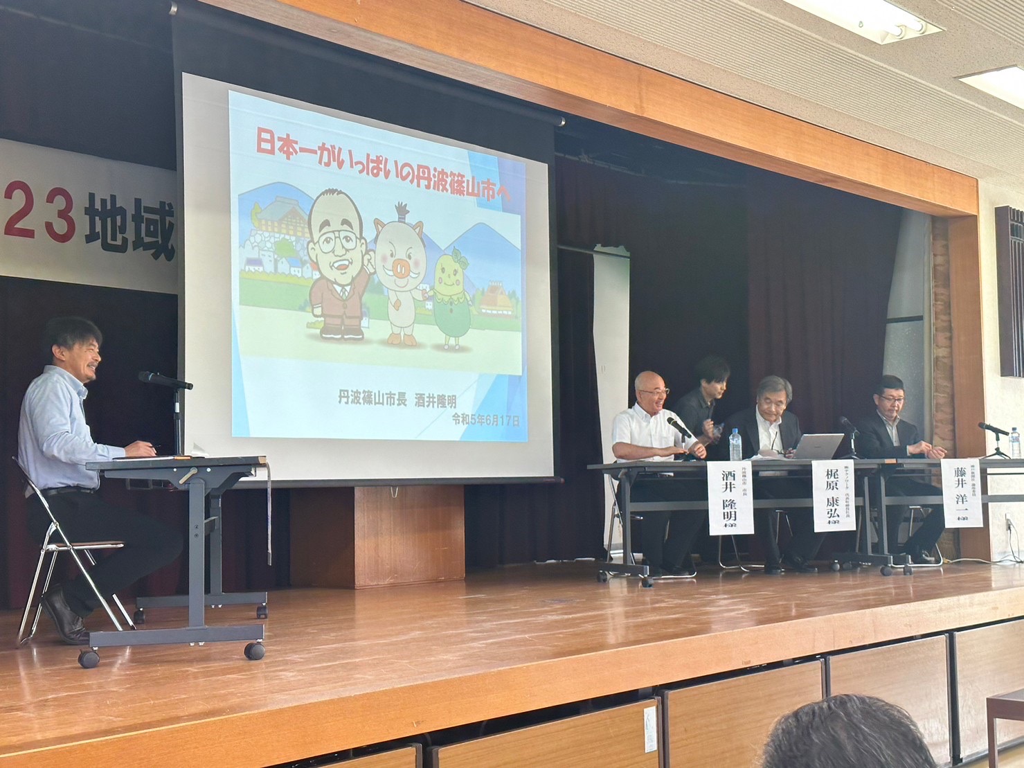 フォーラム時、前のスライドと市長、梶原社長、藤井さん