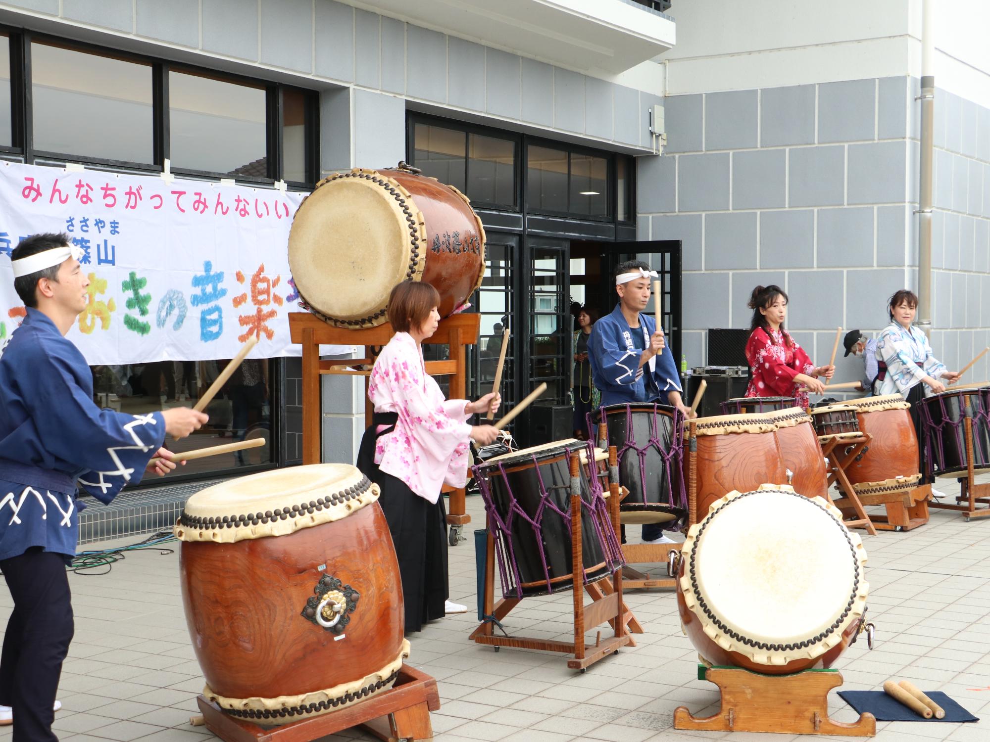 鼓篠組の皆さんが屋外で太鼓の演奏を披露している