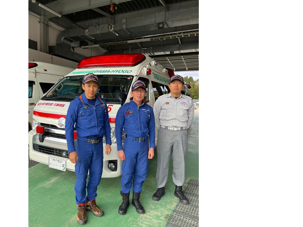 救急車の前で撮影した緊急消防援助隊第1陣の3人