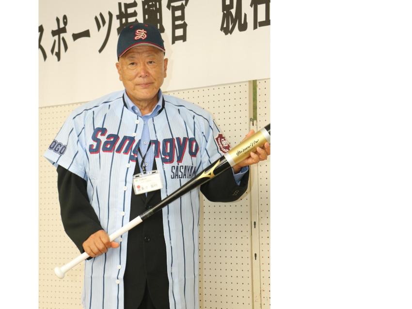 産業高校のユニフォームを着て、バットを手に持った長澤先生