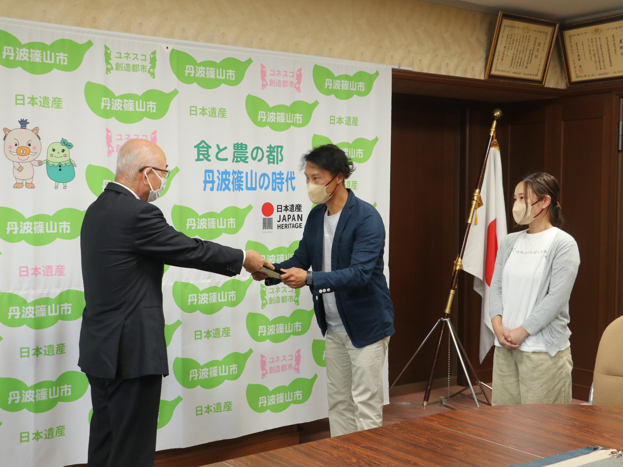 市長が認定書を手渡している