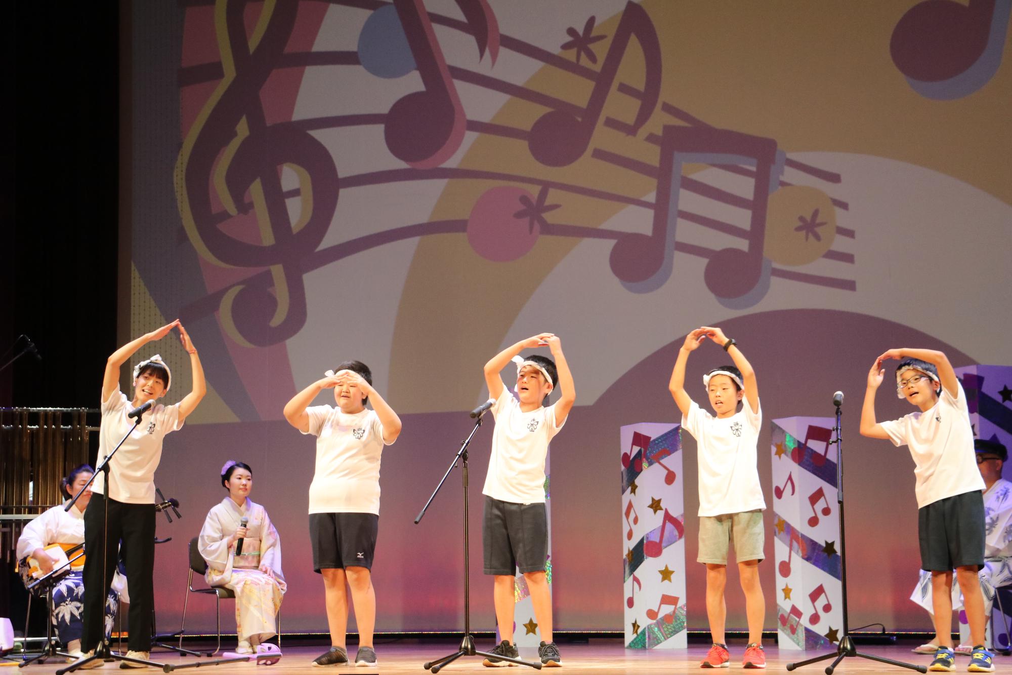 デカンショのど自慢に出場された篠山小学校チームこども4人と先生が歌っている