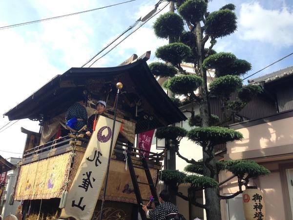 春日神社の祭礼が行われ山車に人が乗っている写真