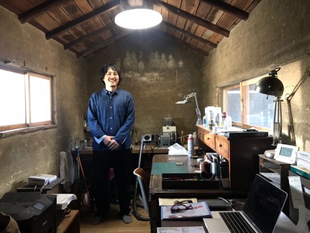 作業場の中央に職人の男性が立っている