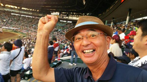 茶色い麦わらハットをかぶった市長が嬉しそうに満面の笑みでガッツポーズをしている写真