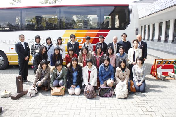 大きなバスの前で高校生たちと市長が記念撮影写真