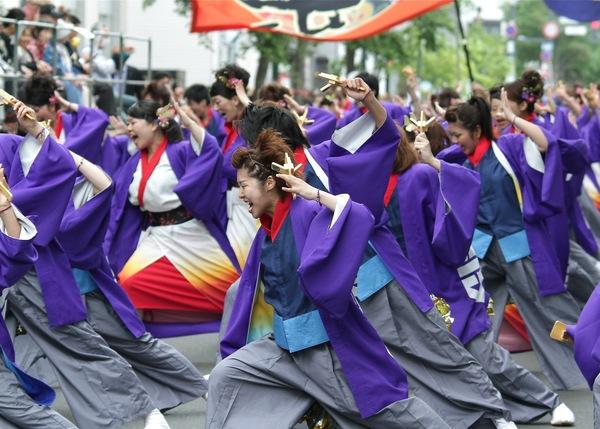 紫色のはっぴを着、縦に長く並んで一生懸命踊っている丹波篠山楽空間一期一会の皆さんの写真