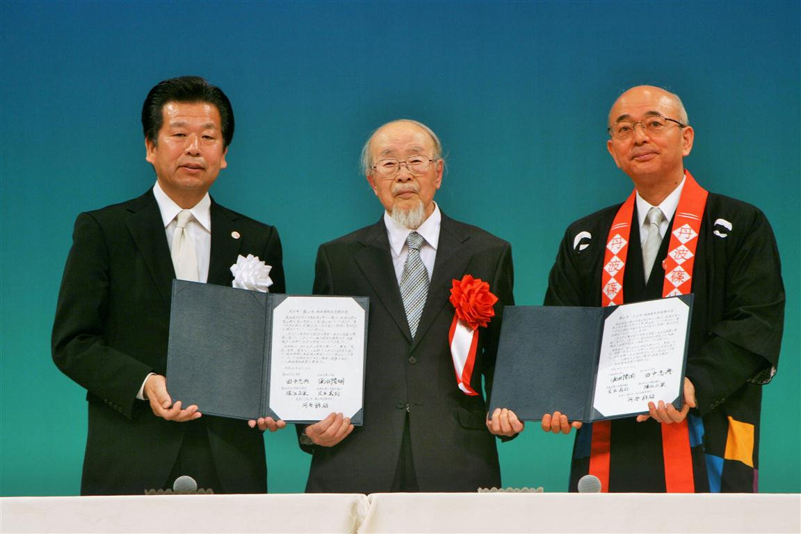 河合雅雄先生が真ん中で協定書を持っている