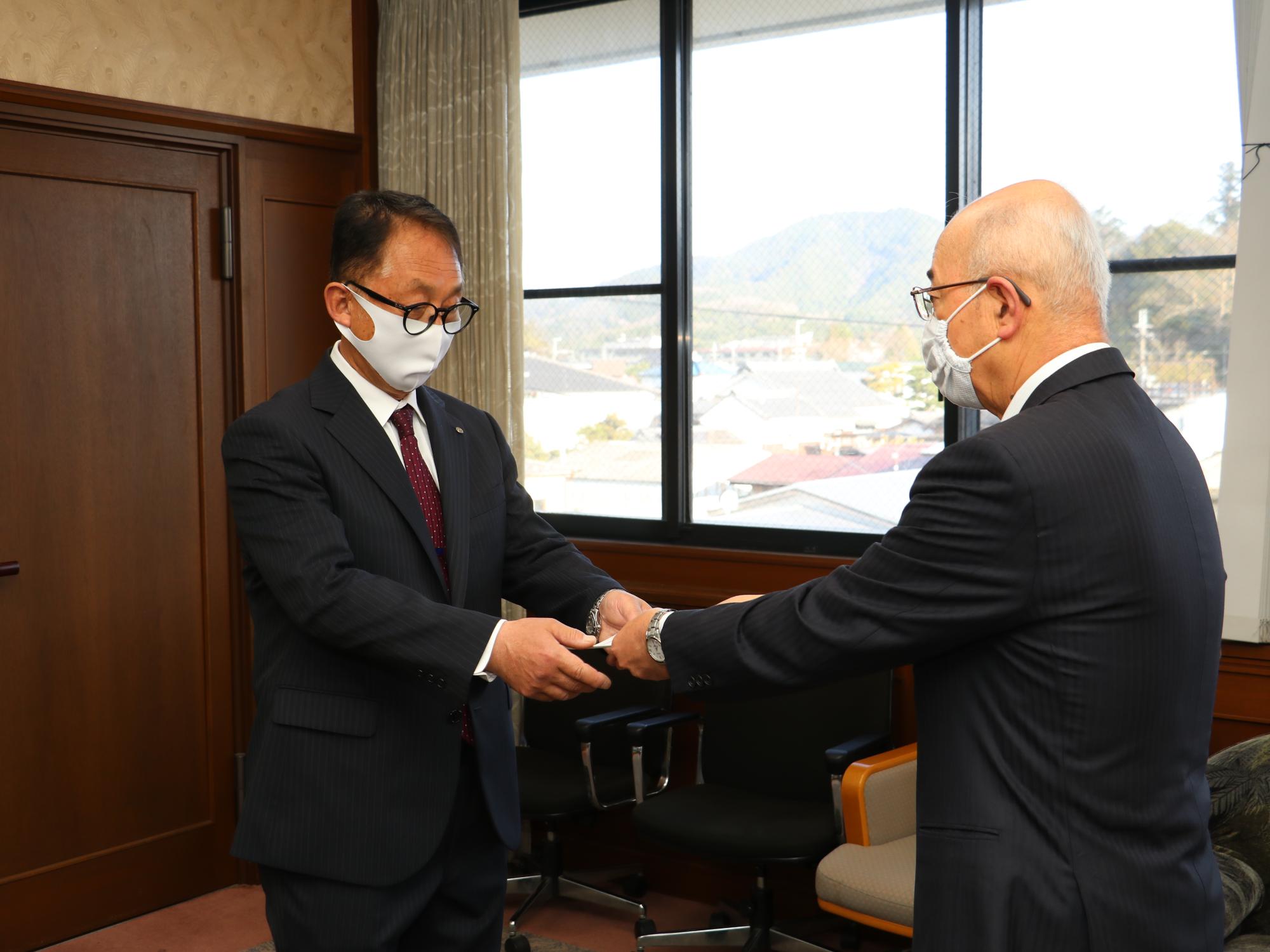 市長から辞令を受け取っている