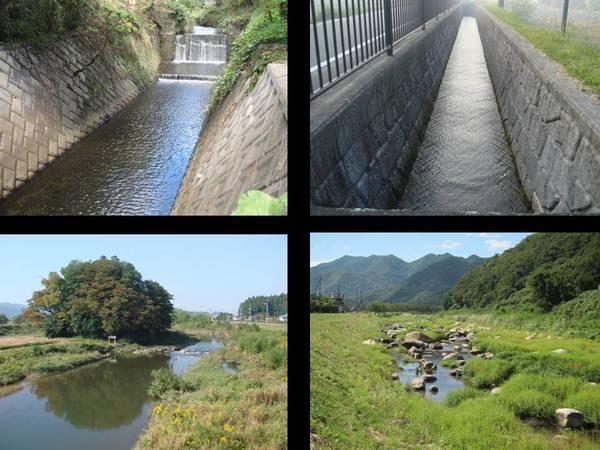 川や下水のコンクリート三面張りとみどりいっぱいの山の写真