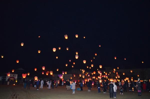 夜空にランタンがたくさん飛んでいる写真