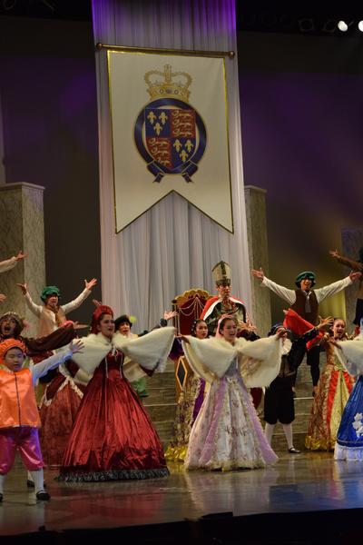 両手を広げ音楽に合わせて歌っている出演者の写真