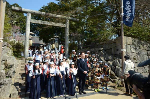 神社の石段に鎧を羽織った子供達や袴姿の女の子が並び記念写真