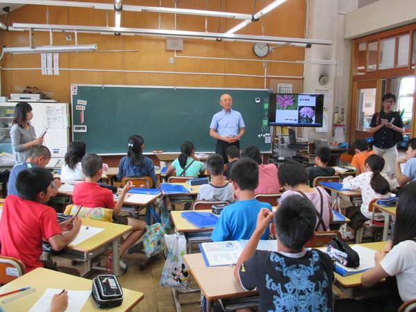 15名ほどの子どもたちが座っている教室の黒板の前に市長が立っている写真