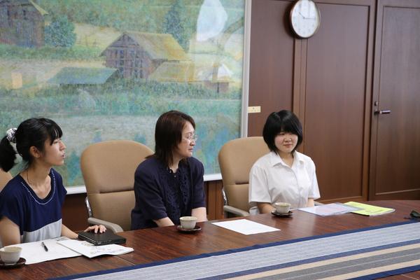 黒田 楓花さんとお母さん、畑先生で机に座り黒田さんがお話している写真