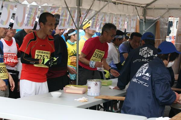 スタッフの方が準備した炊き出しを、ランナーが順番に並び待っている写真