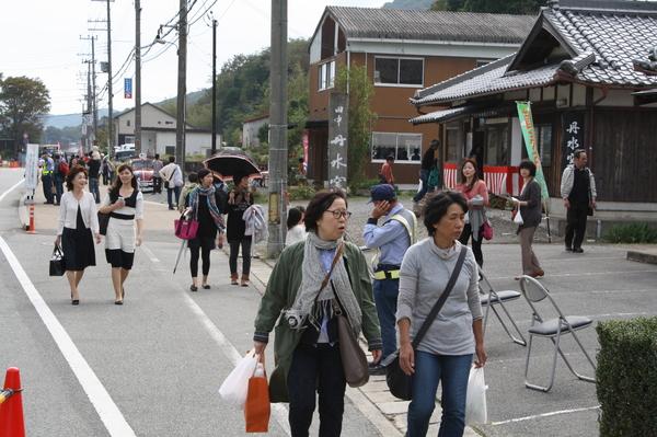 手に紙袋や、袋を持って歩く人々の写真
