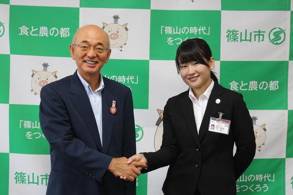市長と笑顔で握手している中西 美加さんの写真