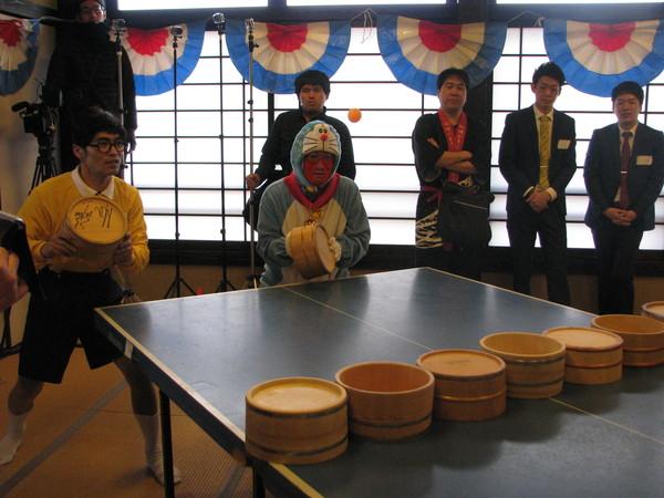 ドラえもんとのび太君の仮装をした2人が、卓球台の前に立って構えている様子の写真