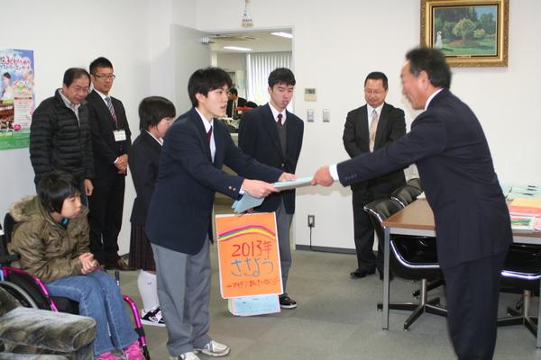 篠山養護学校の代表者の男性生徒が市長にカレンダーを渡している写真