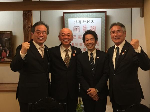 清水さんと市長が中央に写り、両脇の男性がガッツポーズをして写っている写真