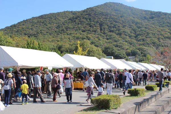 催しが行われており、テントの横を歩く人々の写真