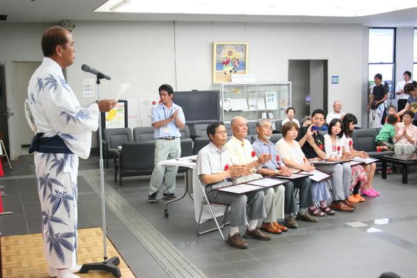 デカンショ道場会員の吉田さんが、浴衣を着て受賞者の前で歌っている写真