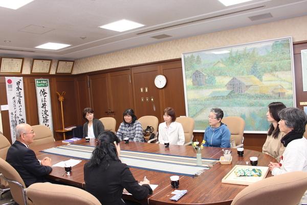 中野母親クラブ6名が市長へ受賞の報告をしているのを横で書記している女性職員も写っている写真