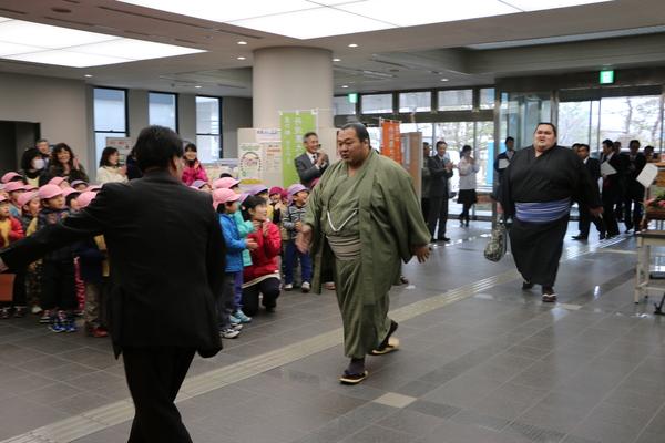 豊ノ島関と付き人、謙豊を、沢山の子供や、関係者が拍手で出迎えている写真
