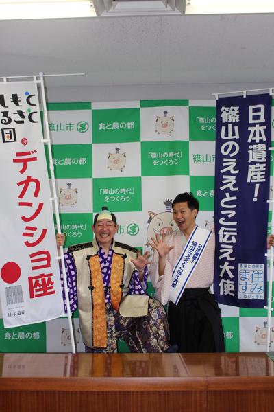 「デカンショ座」ののぼり旗を持った花いちの足立座長がお殿様の衣装を着て「日本遺産篠山のええとこ伝え大使」と書かれているのぼり旗を持った月亭 八斗さんと一緒に写っている写真