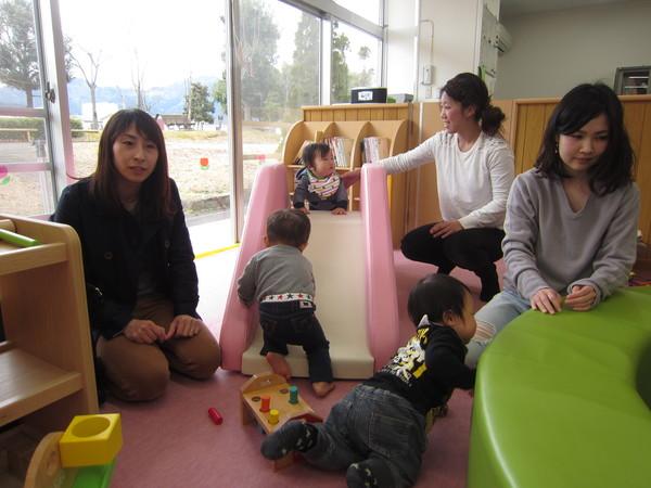 赤ちゃんルームの滑り台やおもちゃで遊ぶ親子の写真