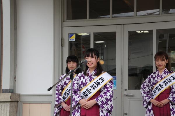 袴を着て丹波篠山観光大使のタスキをする松尾 祐香さんが、マイクの前で話している写真