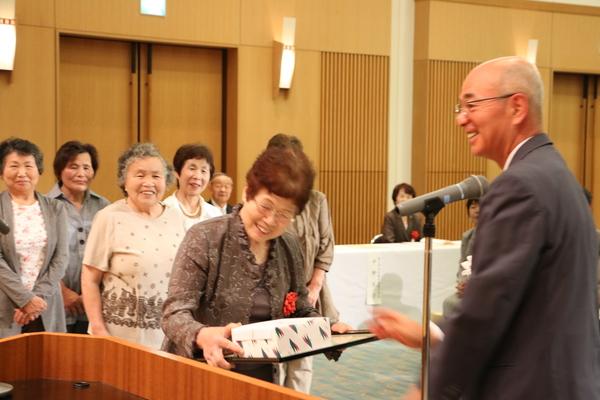 笑顔で記念品と賞状を渡している市長とそれを笑顔で受け取っている女性の写真